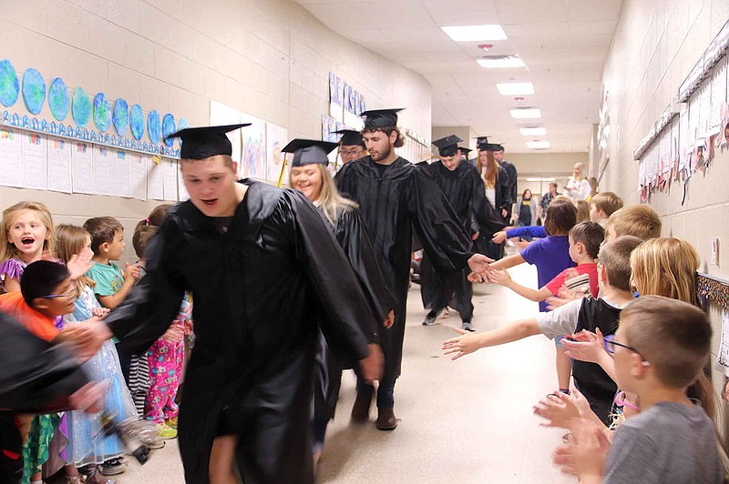LYNN KUTTER ENTERPRISE-LEADER
Students at Prairie Grove Elementary School congratulate members of the Prairie Grove Class of 2021 as the seniors walk through the halls of the elementary school on Friday. Prairie Grove's graduation ceremony will be 6 p.m., May 15, at Tiger Stadium.