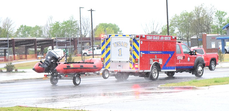 Westside Eagle Observer/MIKE ECKELS
An Urban Search and Rescue truck towing a Zodiac boat races down U.S. Highway 412 in Tontitown April 28 on its way to a swift water rescue somewhere in the Washington County area. Around three inches of rain fell in a 12 hour period, prompting the National Weather Service to issue Flash Flood Warning leading to the need for deployment of these specialized units.