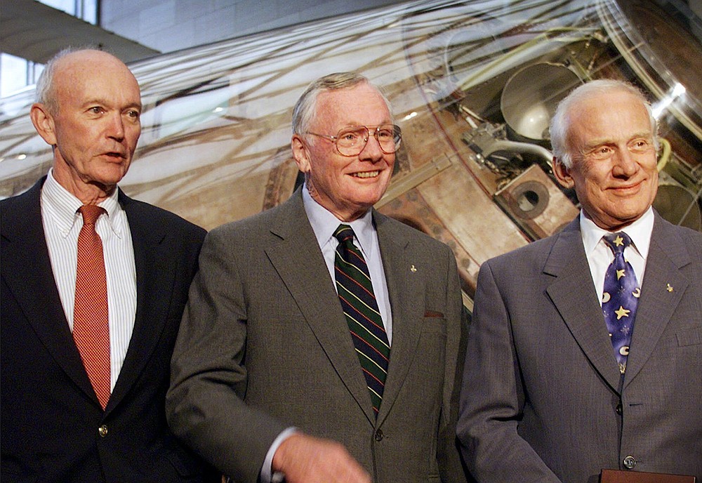 FILE - In this July 20, 1999 file photo, Apollo 11 astronauts, from left, Michael Collins, Neil Armstrong, and Edwin "Buzz" Aldrin, are awarded the Samuel P. Langley medal, at a ceremony at the Smithsonian's Air and Space Museum in Washington. Collins, who piloted the ship from which Armstrong and Aldrin left to make their historic first steps on the moon in 1969, died Wednesday, April 28, 2021, of cancer, his family said. He was 90. (AP Photo/Doug Mills, File)