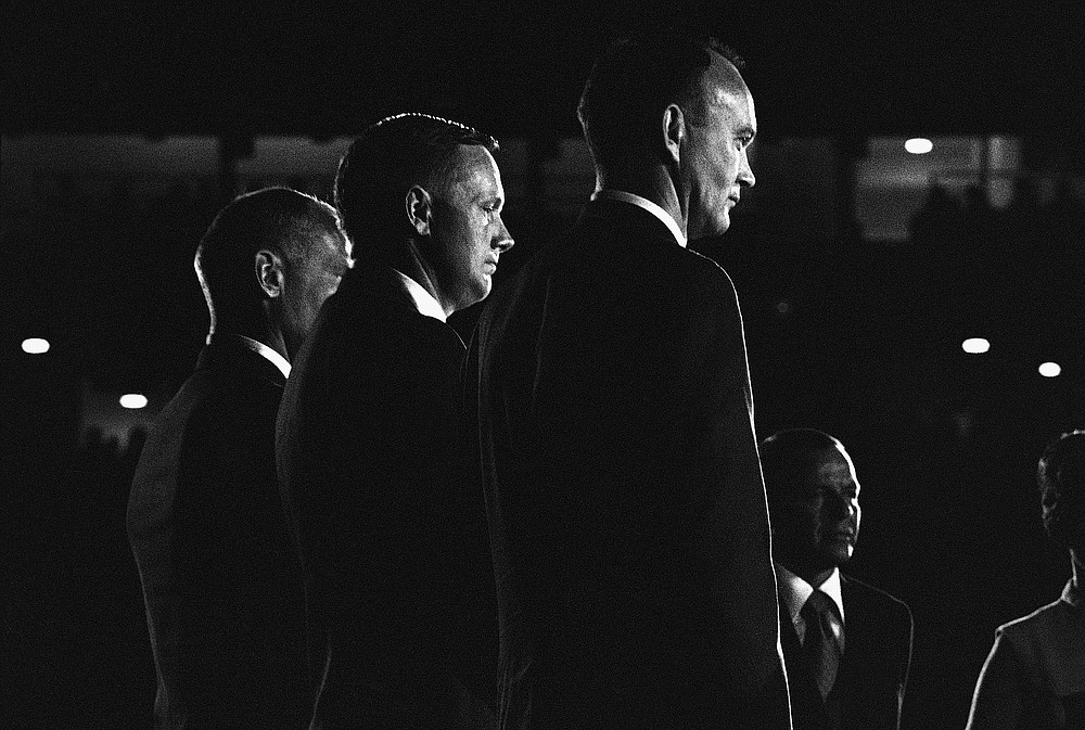 FILE - In this Aug. 16, 1969 file photo, Apollo 11 astronauts, from left, Edwin "Buzz" Aldrin, Neil Armstrong and Michael Collins stand on stage at the Astrodome in Houston, waiting to be presented medals by the city. At right is Frank Sinatra who was master of ceremonies. Collins, who piloted the ship from which Neil Armstrong and Buzz Aldrin left to make their historic first steps on the moon in 1969, died Wednesday, April 28, 2021, of cancer, his family said. He was 90. (AP Photo)