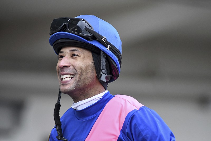 This photo provided by NYRA shows Kendrick Carmouche smiling in the paddock at Aqueduct Racetrack in the Queens borough of New York on Jan. 24, 2020. Carmouche is set to ride Bourbonic in the Kentucky Derby, the first Black jockey in the race since 2013. (NYRA Photos/Coaglianese via AP)