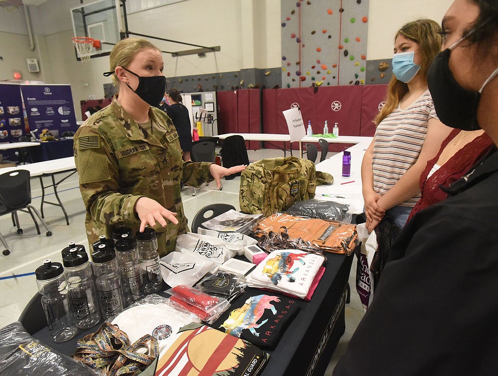 Staff Sgt. Vaughan Cox talks Wednesday April 28 2021 with Rogers New Technology High School students about the benefits of the Army National Guard. Dozens of corporations and organizations took part in the school's internship fair. Go to nwaonline.com/210429Daily/ to see more photos.
(NWA Democrat-Gazette/Flip Putthoff)