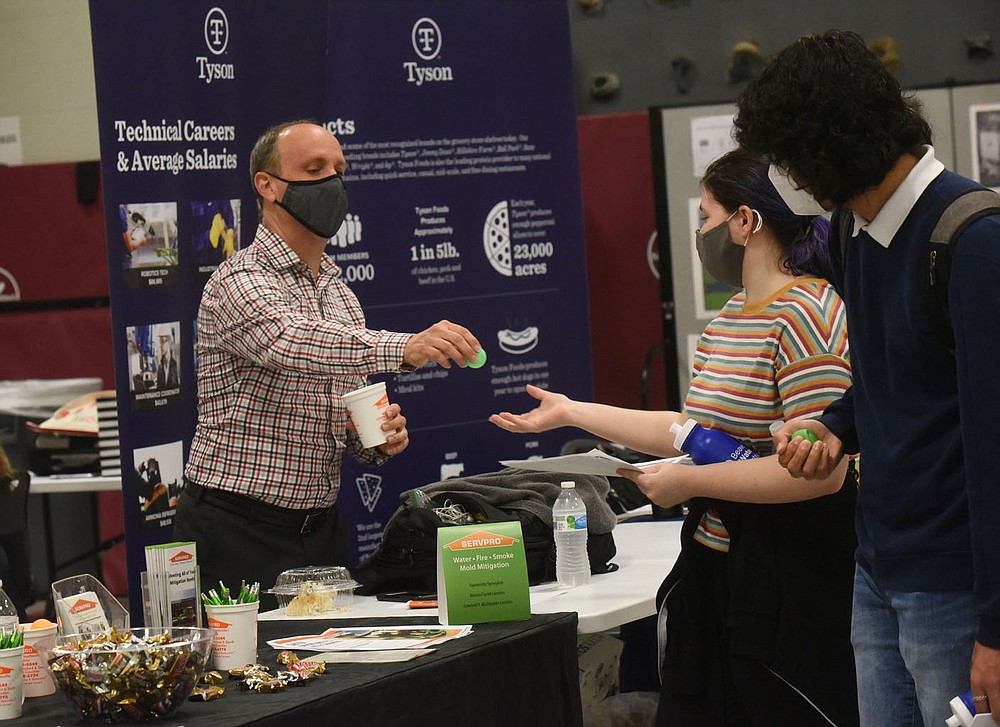 Brian Devecsery with Servpro plays a ball game with students on Wednesday at the internship fair in Rogers. Go to nwaonline.com/210429Daily/ to see more photos.
(NWA Democrat-Gazette/Flip Putthoff)