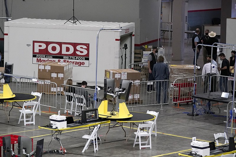 Some of the 2.1 million ballots cast during the 2020 election, are brought in for recounting at a 2020 election ballot audit ordered by the Republican lead Arizona Senate at the Arizona Veterans Memorial Coliseum, during a news conference Thursday, April 22, 2021, in Phoenix. The equipment used in the November election won by President Joe Biden and the 2.1 million ballots were moved to the site Thursday so Republicans in the state Senate who have expressed uncertainty that Biden's victory was legitimate can recount them and audit the results. (AP Photo/Ross D. Franklin)