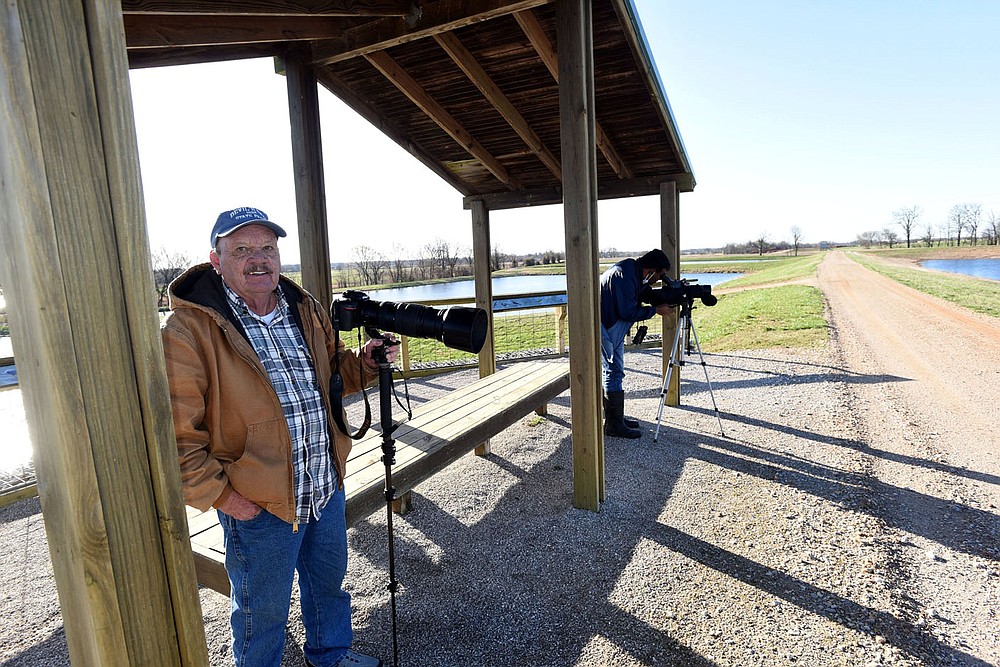 Terry Stanfill (left) and Vivek Govind Kumar watch for birds in March 2021 at the Charlie Craig State Fish Hatchery in Centerton. The Arkansas Game and Fish Commission raises walleye, catfish at other species at the hatchery. It's 17 ponds and surrounding habitat attract a variety of birds.