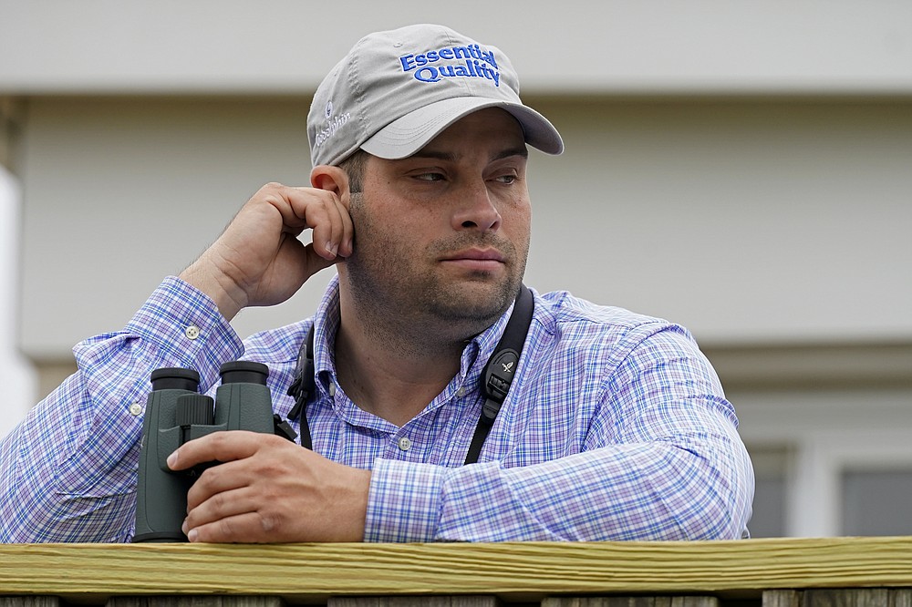 Brad Cox, trainer for Kentucky Derby entrant Essential Quality, watches a workout at Churchill Downs Thursday, April 29, 2021, in Louisville, Ky. The 147th running of the Kentucky Derby is scheduled for Saturday, May 1. (AP Photo/Charlie Riedel)