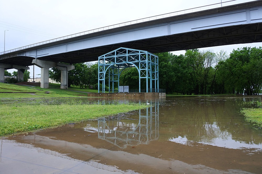 The stage of the Riverfront Amphitheater next to the Arkansas River in Fort Smith is surrounded by water after heavy rainfall Thursday. 
(NWA Democrat-Gazette/Thomas Saccente)