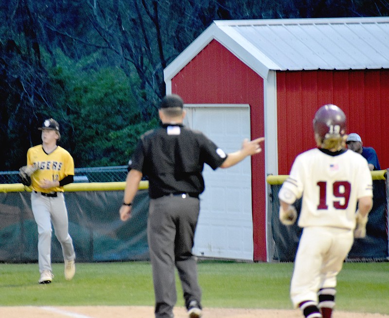 MARK HUMPHREY  ENTERPRISE-LEADER/Prairie Grove first baseman Connor Hubbs (left) makes a catch in foul territory to record an out in the fifth inning. Moments earlier the field umpire inadvertently close-lined Hubbs preventing him from making a similar play. The Tigers got out of the inning unscathed, but gave up an RBI double to Slayter Watkins with two outs in the bottom of the seventh and lost, 3-2, in the first-round of District 4A-1 baseball action on Tuesday, April 27. The loss ended Prairie Grove's season.