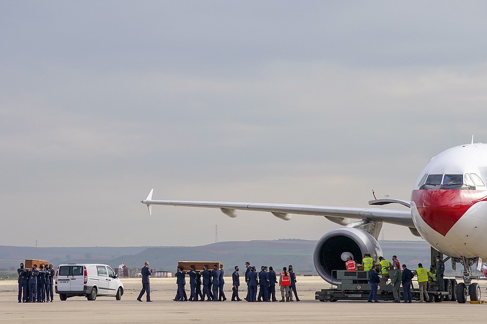 Coffins carrying the bodies of Spanish reporters David Beriain, Roberto Fraile and the director of the Chengeta Wildlife Foundation Rory Young, arrive from Burkina Faso at the Madrid military airport on Friday, April 30, 2021. Two Spanish journalists and the Irish director of a wildlife foundation were killed Monday in an ambush in eastern Burkina Faso. The two journalists were working with the wildlife campaigner on a documentary about poachers in a national park bordering Benin when they were attacked by gunmen. AP Photo/Andrea Comas)