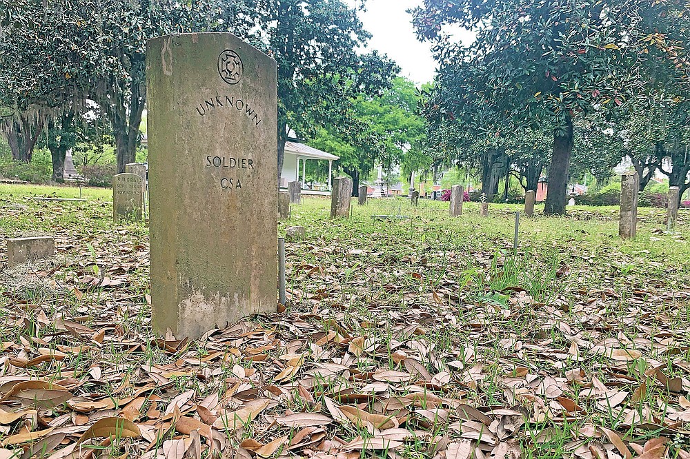 A gravestone marks the grave of a unknown soldier at the Confederate Memorial Circle, a private section of Live Oak Cemetery in Selma, Ala.., Tuesday, April 13, 2021, where chair carved out of limestone honoring Confederate President Jefferson Davis was stolen. Police recovered the chair in New Orleans. (AP Photo/Kim Chandler)