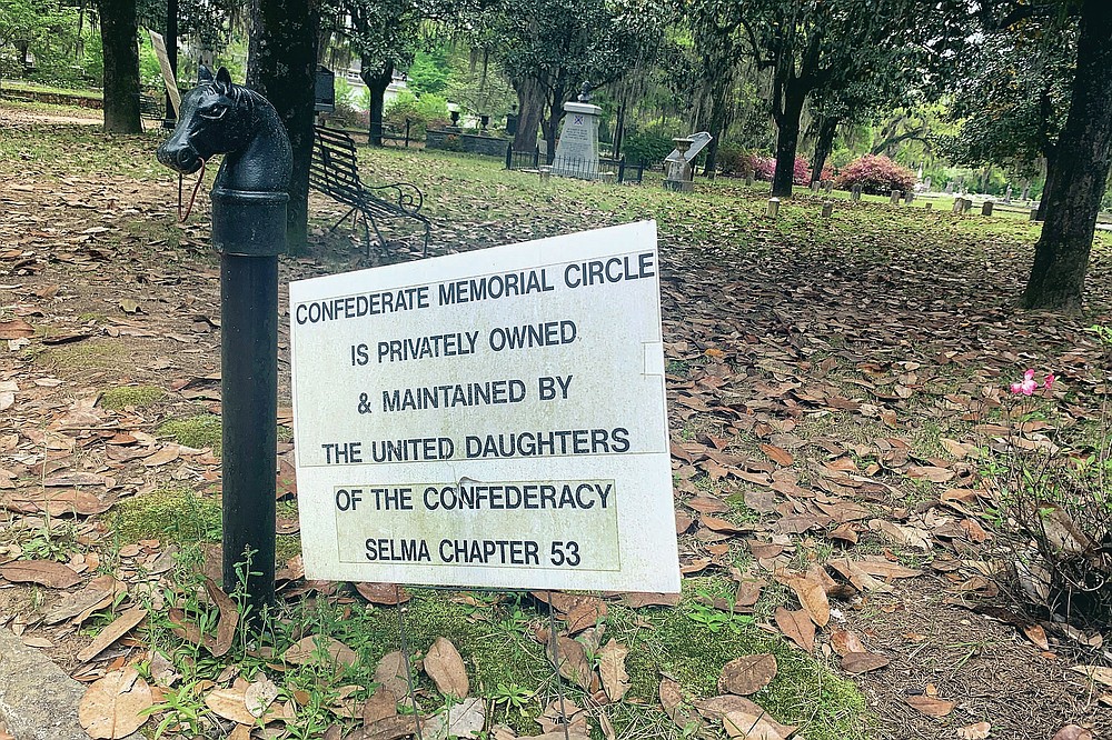 A sign hangs at the Confederate Memorial Circle, a private section of Live Oak Cemetery in Selma, Ala.., Tuesday, April 13, 2021, where chair carved out of limestone honoring Confederate President Jefferson Davis was stolen. Police recovered the chair in New Orleans. (AP Photo/Kim Chandler)