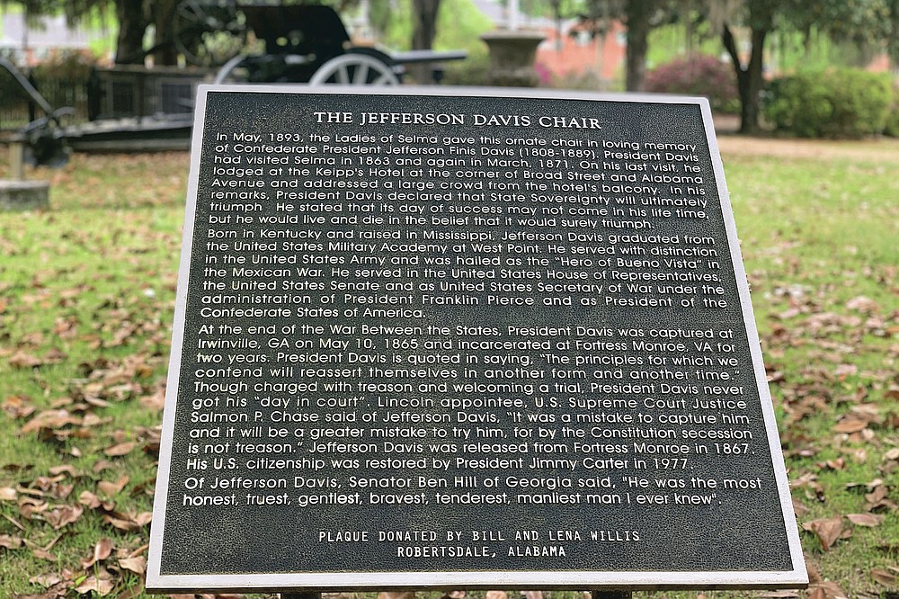 A plaque commemorates where a chair carved out of limestone honoring Confederate President Jefferson Davis used to sit, Tuesday, April 13, 2021 at the Confederate Memorial Circle, a private section of Live Oak Cemetery in Selma, Ala. Police recovered the stolen chair in New Orleans. (AP Photo/Kim Chandler)