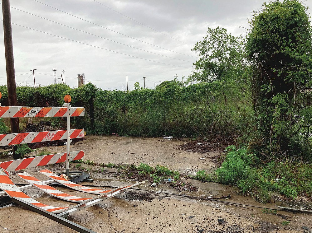 This Wednesday, April 14, 2021, photo shows the area next to a railroad overpass in New Orleans, where authorities earlier recovered a chair carved out of limestone that was a monument to the only president of the Confederacy, Jefferson Davis. The chair had been stolen from a Selma, Ala., cemetery. (AP Photo/Rebecca Santana)