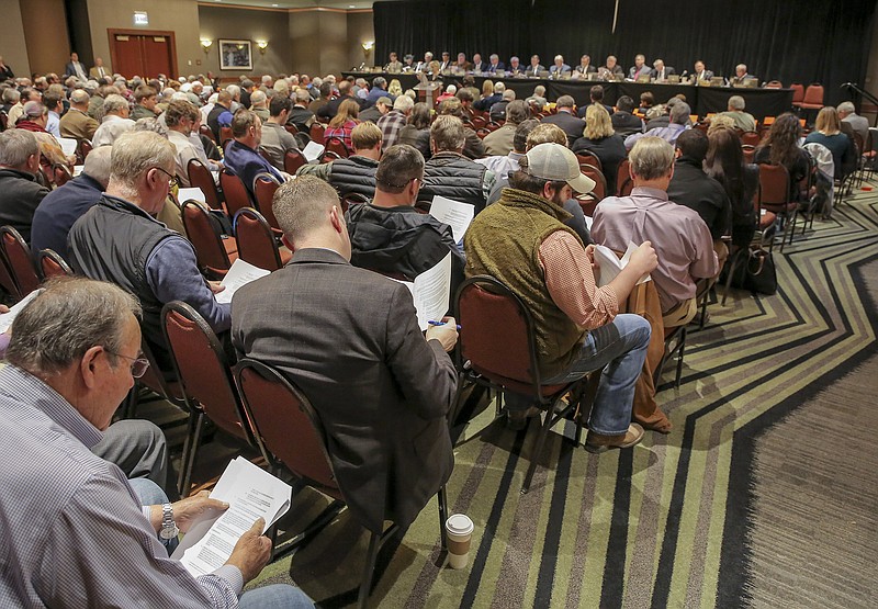 FILE — Participants at a meeting of the state Plant Board at the Embassy Suites Hotel in west Little Rock look over proposed rules for the use of the herbicide dicamba in this February 2019 file photo. (Arkansas Democrat-Gazette/John Sykes Jr.)
