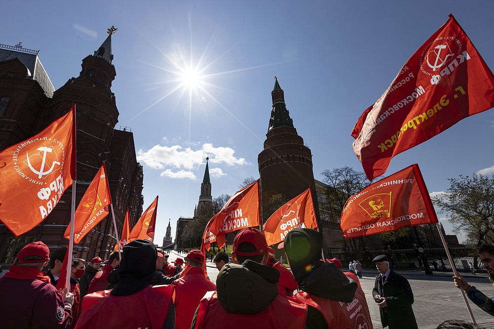 Communists party supporters gather with red flags to mark Labour Day, also knows as May Day near Red Square in Moscow, Russia, Saturday, May 1, 2021. (AP Photo/Alexander Zemlianichenko)