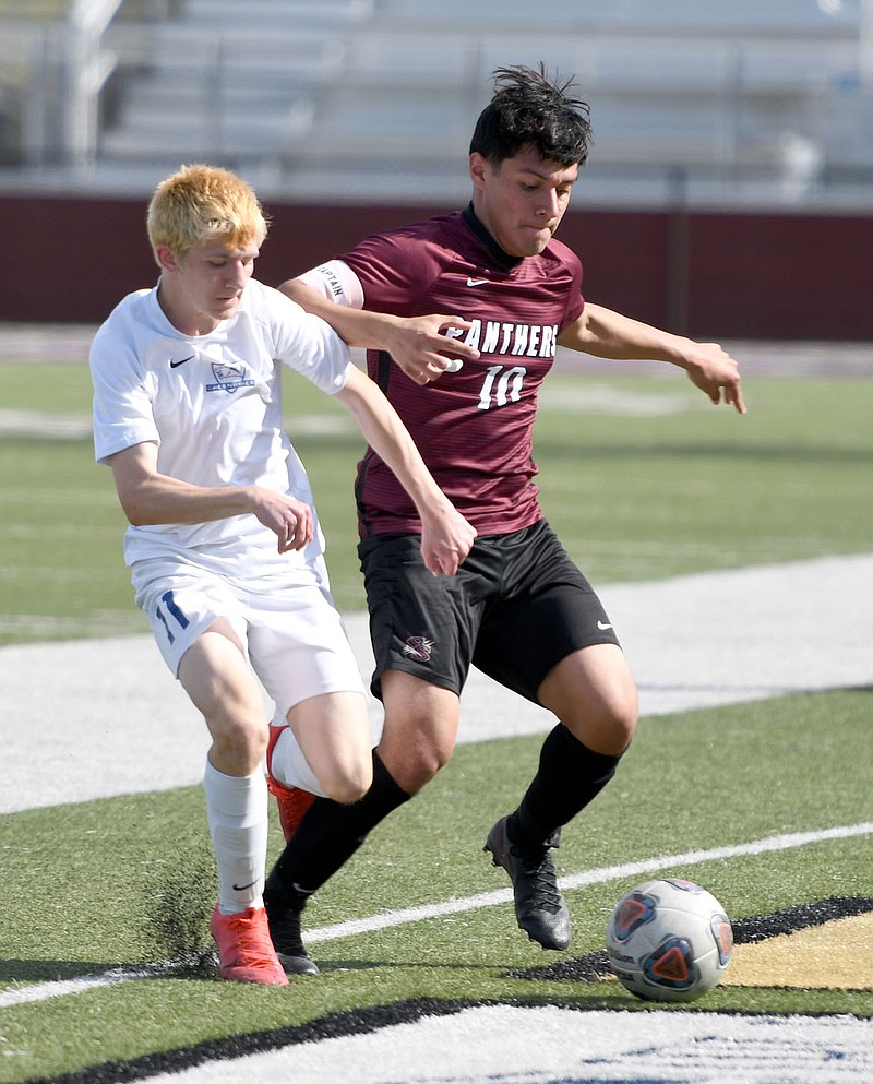 Bud Sullins/Special to the Herald-Leader
Siloam Springs senior forward Franklin Cortez battles a Greenbrier defender for possession of the ball during a game on April 26. Cortez leads the Panthers with 19 goals and 16 assists.