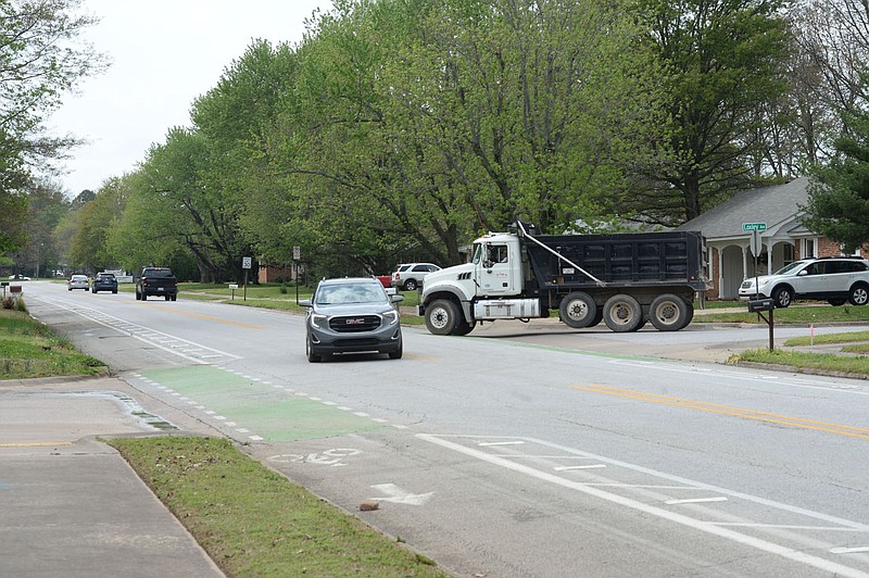 Traffic passes Thursday, April 29, 2021, through the intersection of Rolling Hills Drive and Loxley Avenue in Fayetteville. The city has a planned $4.4 million project using money voters approved in April 2019 to redesign Rolling Hills Drive with two mini-roundabouts, new pedestrian crossings and narrower driving lanes, with a turning lane in the middle. Visit nwaonline.com/210430Daily/ for today's photo gallery. 
(NWA Democrat-Gazette/Andy Shupe)