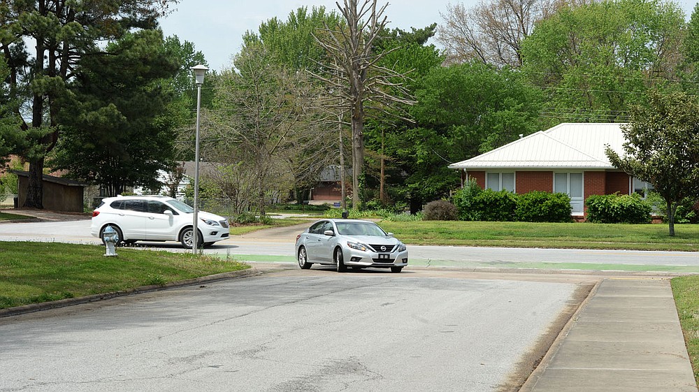 Traffic turns south onto Loxley Avenue Thursday, April 29, 2021, off of Rolling Hills Drive in Fayetteville. The city has a planned $4.4 million project using money voters approved in April 2019 to redesign Rolling Hills Drive with two mini-roundabouts, new pedestrian crossings and narrower driving lanes, with a turning lane in the middle. Visit nwaonline.com/210430Daily/ for today's photo gallery.
(NWA Democrat-Gazette/Andy Shupe)