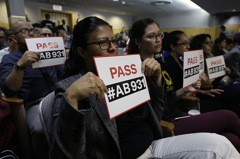 FILE - In this June 19, 2018 file photo, Rosa Cabrera, foreground, joined others in support of a measure to limit police use of deadly force, during a hearing of the Senate Public Safety Committee in Sacramento, Calif.  Cases involving police use of force often include questions about the internal records of the officers involved, records that in most cases are off-limits to the press and public.  Lawmakers in at least 13 states have considered bills this year to make those records more publicly available. (AP Photo/Rich Pedroncelli, File)