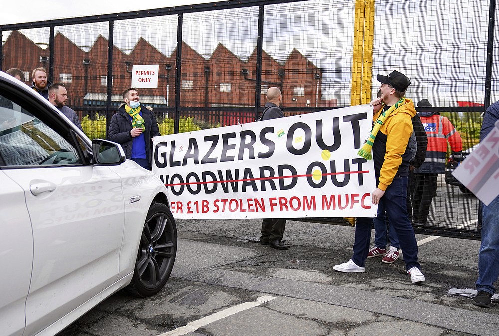 Manchester United fans prevent cars arriving at Old Trafford, during a protest against the Glazer family, owners of Manchester United, before their Premier League match against Liverpool at Old Trafford, Manchester, England, Sunday, May 2, 2021. Manchester United supporters have stormed into the stadium and onto the pitch ahead of Sunday’s game against Liverpool as fans gathered outside Old Trafford to protest against the ownership. (AP Photo/Dave Thompson)