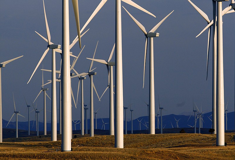 FILE - This May 6, 2013 file photo shows a wind turbine farm owned by PacifiCorp near Glenrock, Wyo. While most states pursue ways to boost renewable energy, Wyoming is doing the opposite with a new program aimed at propping up the dwindling coal industry by suing other states that block exports of Wyoming coal and cause Wyoming coal-fired power plants to shut down. The law signed April 6 by Republican Gov. Mark Gordon creates a $1.2 million fund for an initiative that marks the latest attempt by state leaders to help coal in the state that accounts for the bulk of U.S. coal production, which is down by half since 2008. (AP Photo/Matt Young, File)