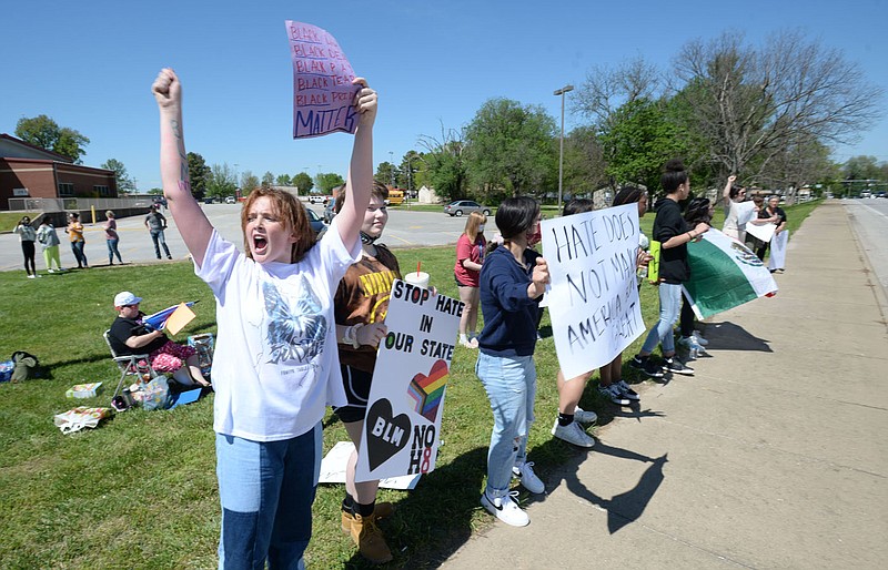 Marie Shillings, 15, (left) a ninth-grader at Farmington Junior High School leads students from the junior high and high schools in chants Friday, April 30, 2021, during a protest along main street near the junior high school after a student was allegedly attacked Tuesday at the school by at least one fellow student. Visit nwaonline.com/210501Daily/ for today's photo gallery. 
(NWA Democrat-Gazette/Andy Shupe)