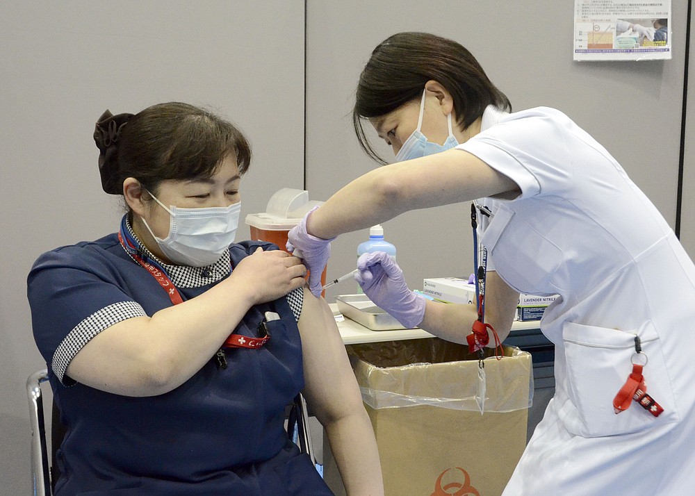A nurse receives the first dose of the Pfizer COVID-19 vaccine at Fujita Health University Hospital in Toyoake, Aichi prefecture, central Japan, on March 8, 2021. Some nurses in Japan are incensed at a request from Tokyo Olympic organizers to have 500 of them dispatched to help out with the games. They say they’re already near the breaking point dealing with the coronavirus pandemic. (Kyodo News via AP)