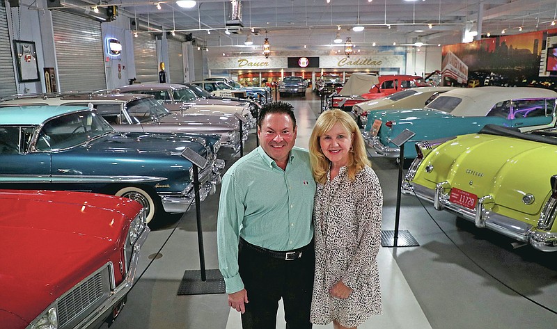 Joanne and Edward Dauer pose at the Dauer Museum of Classic Cars in Sunrise, Fla., on Wednesday, April 21, 2021. (Carline Jean/South Florida Sun-Sentinel via AP)