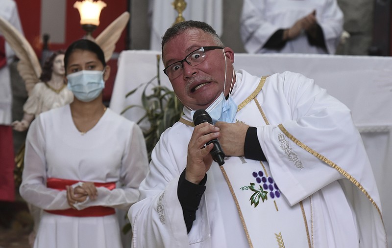 Sergio Valverde Espinoza, a Catholic priest of the Cristo Rey church who modified a popular song called “Sopa de Caracol,” or “Snail Soup” in English, gestures during Mass in San Jose, Costa Rica, on Sunday.
(AP/Carlos Gonzalez)