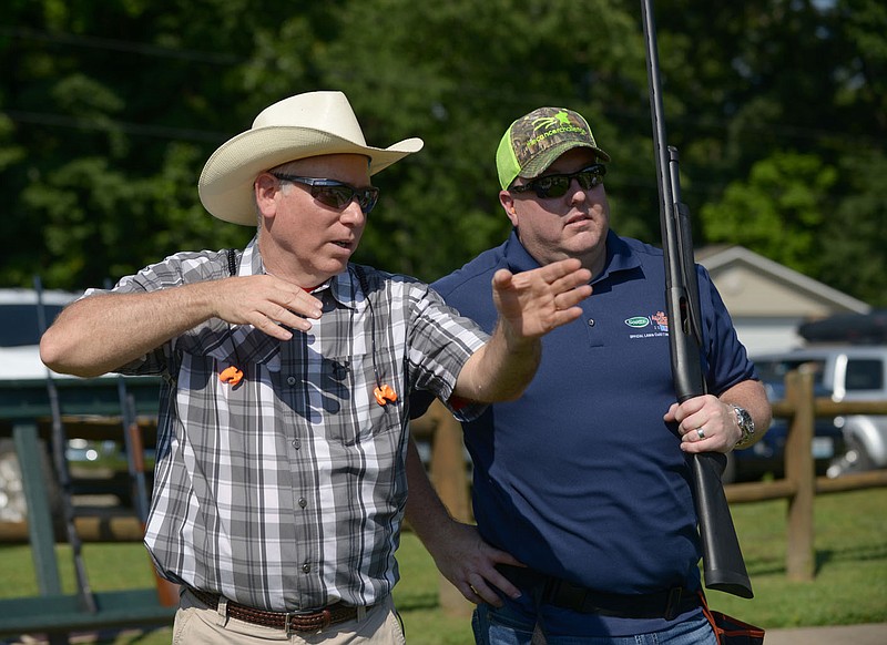 NWA Democrat-Gazette/BEN GOFF @NWABENGOFF
Eddy Kinslow (left) of Rogers gives Leathon Christensen of Fayetteville, a member of a team from The Scott's Company, some pointers on shooting on Friday June 10, 2016 during The Cancer Challenge trap shoot tournament at the Bella Vista Property Owners Association Gun Range.