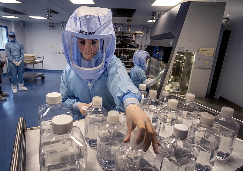 FILE - In this March 27, 2021 file photo a laboratory worker simulates the workflow in a cleanroom of the BioNTech Corona vaccine production in Marburg, Germany, during a media day. Ugur Sahin, BioNTech's chief executive, which developed the first widely approved COVID-19 vaccine with U.S. partner Pfizer, said Europe can achieve 'herd immunity' against the coronavirus within the next four months. (AP Photo/Michael Probst, file)