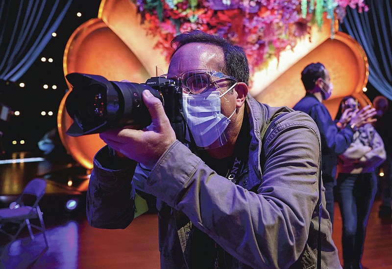 In this image courtesy of Robert Gauthier, AP staff photographer Chris Pizzello photographs the 63rd annual Grammy Awards on Thursday, March 11, 2021 in Los Angeles. (Robert Gauthier via AP)