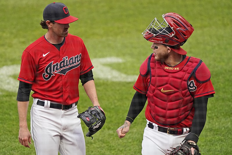 Cleveland Indians starting pitcher Shane Bieber, left, and catcher Roberto Perez walk to the dugout in the first inning of a baseball game against the New York Yankees, Saturday, April 24, 2021, in Cleveland. (AP Photo/Tony Dejak)