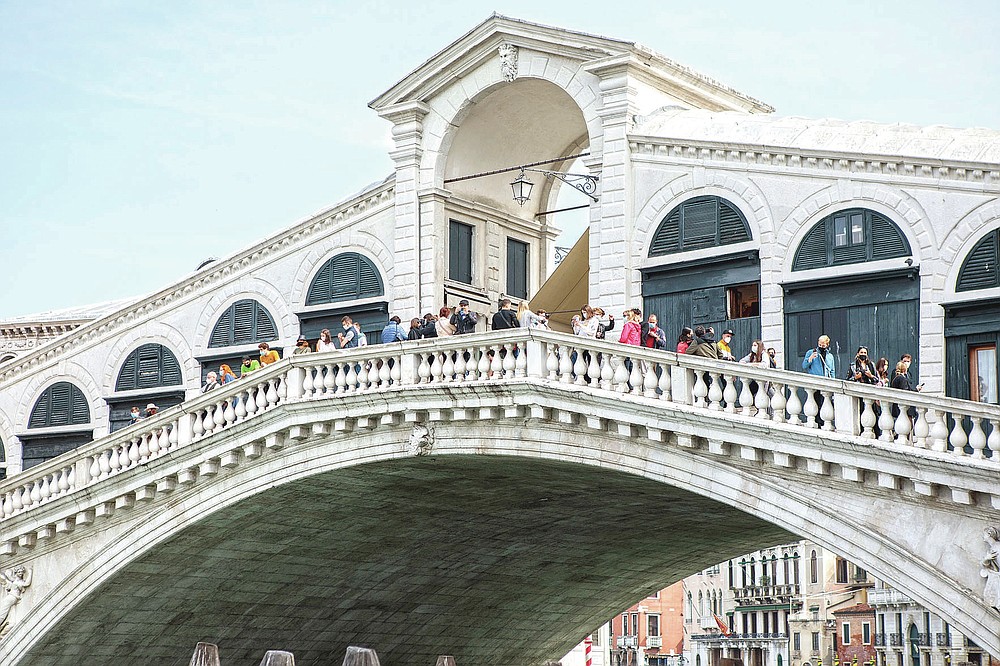 men and women look at the Rialto connection in Venice, northern Italy, Saturday, might 1, 2021. Italy is gradually reopening after 6 months of turning virus closures enabling outdoor food. (Filippo Ciappi/LaPresse via AP)