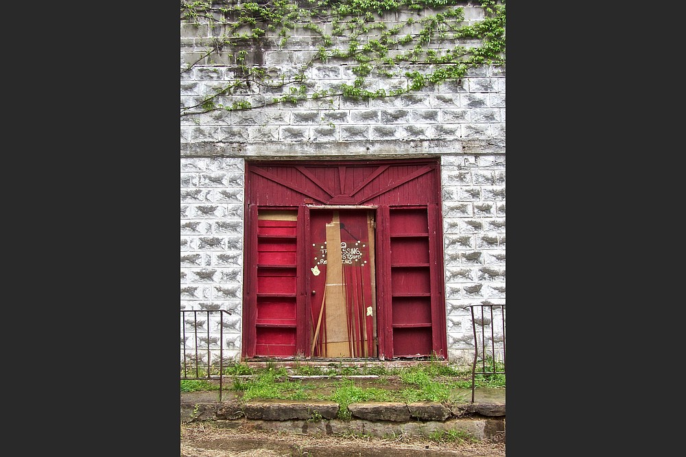 The door of a former funeral home stands ajar in East Calico Historic District. (Special to the Democrat-Gazette/Marcia Schnedler)