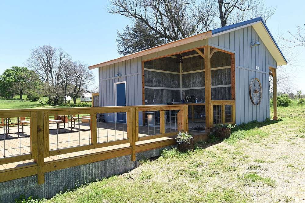 A common kitchen and bathroom building features two outdoor showers, indoor showers, outdoor dining and cooking equipment.
(NWA Democrat-Gazette/Flip Putthoff)