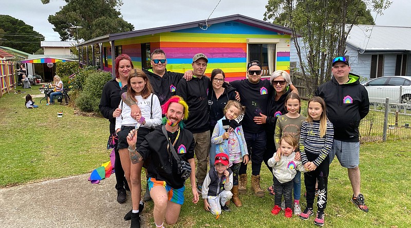 Mykey O’Halloran (front left) poses with some of the volunteers who helped paint his house. (Stephanie Harrison)