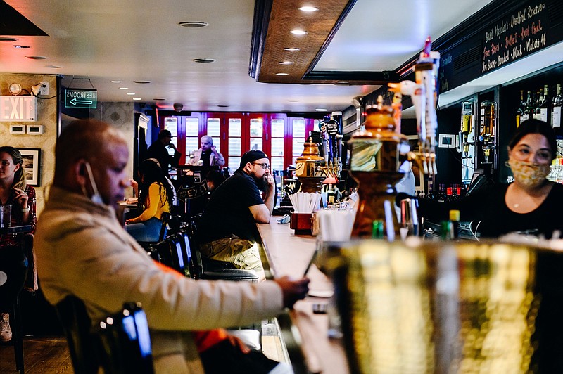 Customers sit at the bar at Blooms Tavern in New York on May 3, 2021. MUST CREDIT: Bloomberg photo by Nina Westervelt.