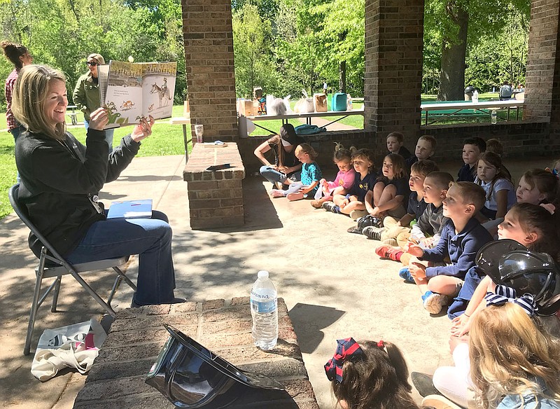 Janelle Jessen/Herald-Leader
Mary Grayson, children's librarian for the Siloam Springs Public Library, reads to a group of kindergarten students from Sager Classical Academy in Bob Henry Park on Wednesday. Students from the private school also toured local businesses and visited the fire station.