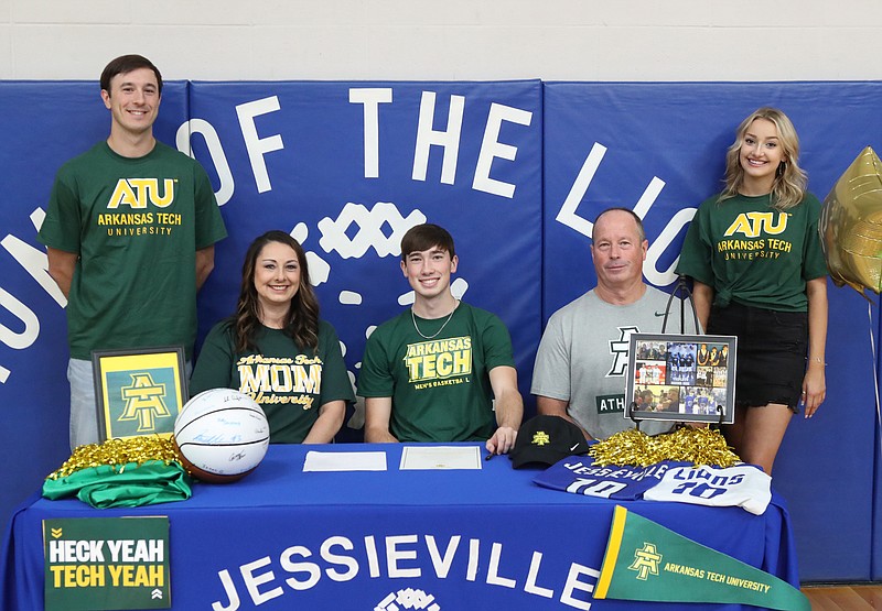 Jessieville’s Jarrett Davis, center, smiles after signing to play basketball at Arkansas Tech Friday. He was joined by, from left, his brother Braden, mother Kim, father Kevin, and girlfriend Elizabeth Dorsett. - Photo by Richard Rasmussen of The Sentinel-Record