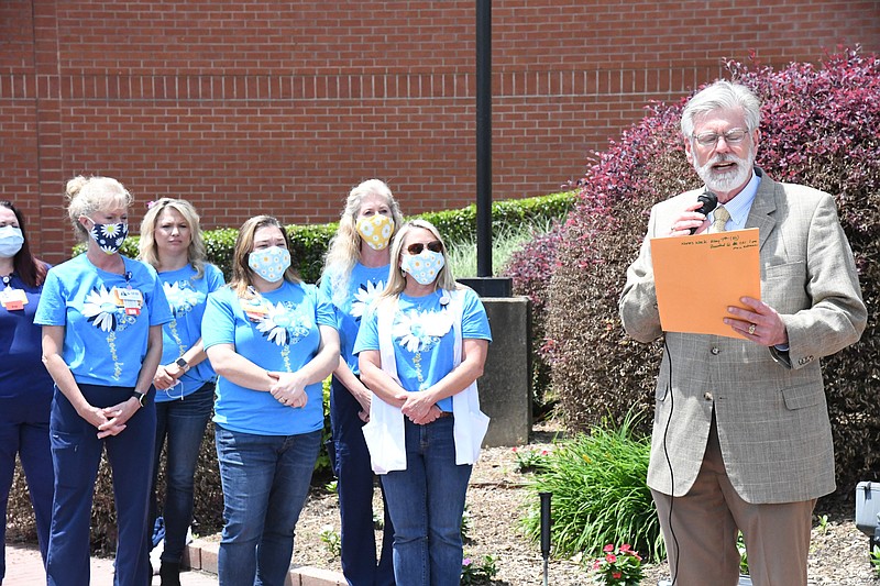 Hot Springs Mayor Pat McCabe reads a proclamation in recognition of Nurses Week Friday at National Park Medical Center as nurses who are members of the DAISY Award selection committee listen. - Photo by Tanner Newton of The Sentinel-Record