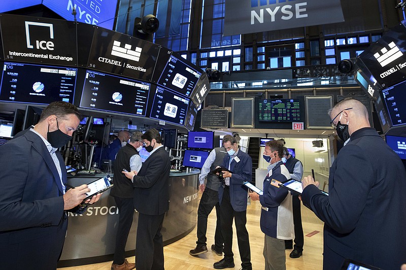 In this photo provided by the New York Stock Exchange, traders work on the floor, Friday, May 7, 2021. Stocks are rallying to records on Wall Street Friday despite a stunningly disappointing report on the nation's job market, as investors see it helping to keep interest rates low. (Nicole Pereira/New York Stock Exchange via AP)