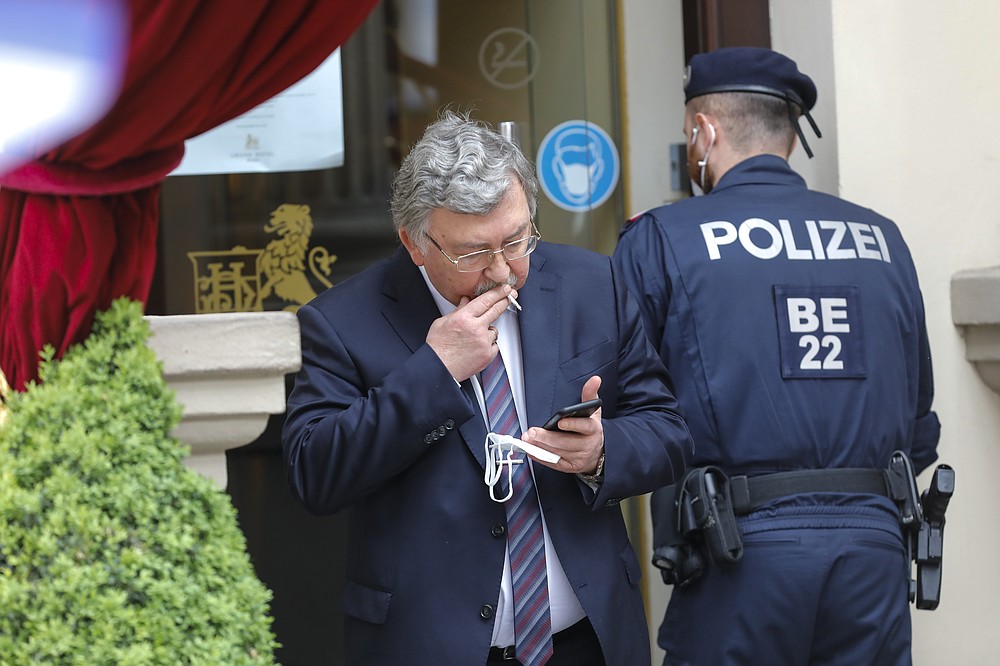 Russia's Governor to the International Atomic Energy Agency (IAEA), Mikhail Ulyanov, has a cigarette break outside of the 'Grand Hotel Wien' where closed-door nuclear talks with Iran take place in Vienna, Austria, Friday, May 7, 2021. (AP Photo/Lisa Leutner)