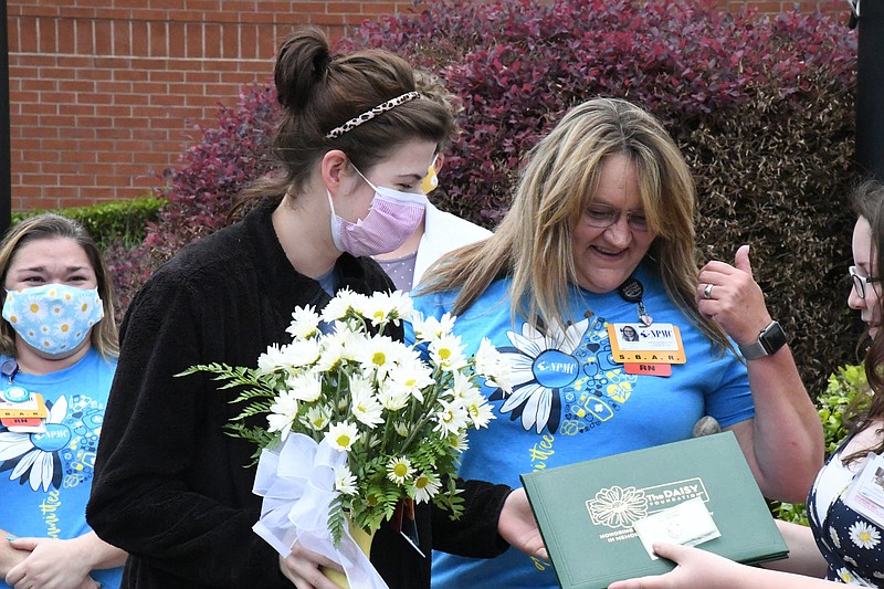 Karissa Owens, left, with Jewell Briggs, ICU director, received the DAISY Award on Friday at National Park Medical Center. - Photo by Tanner Newton of The Sentinel-Record