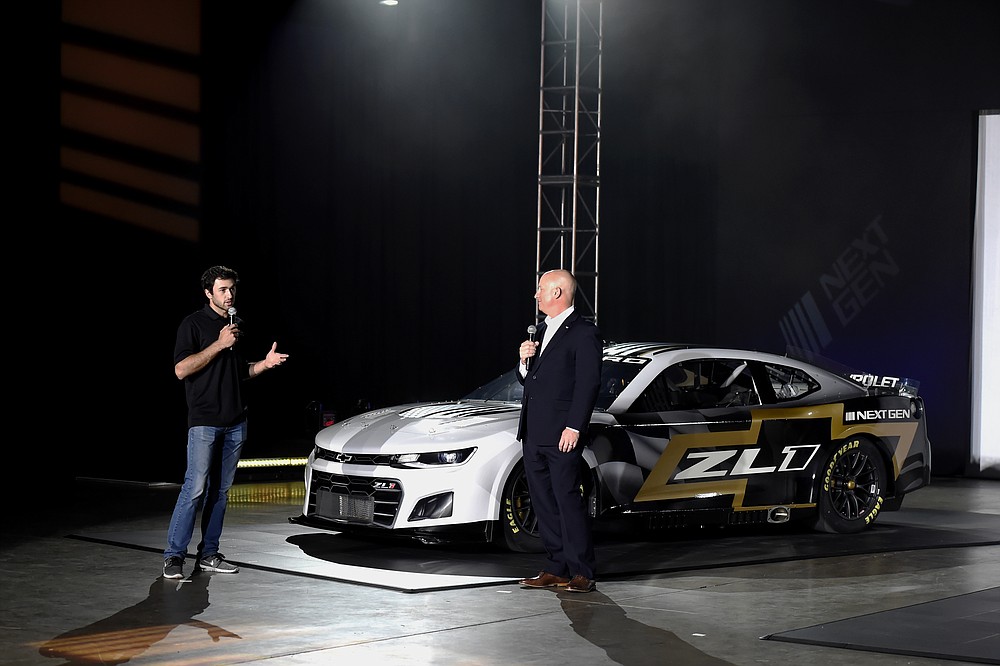 Driver Chase Elliott and Eric Warren, Director, NASCAR Programs with General Motors talk about the Next Gen Camaro that will be used in the 2022 season during the NASCAR media event in Charlotte, N.C., Wednesday, May 5, 2021. (AP Photo/Mike McCarn)