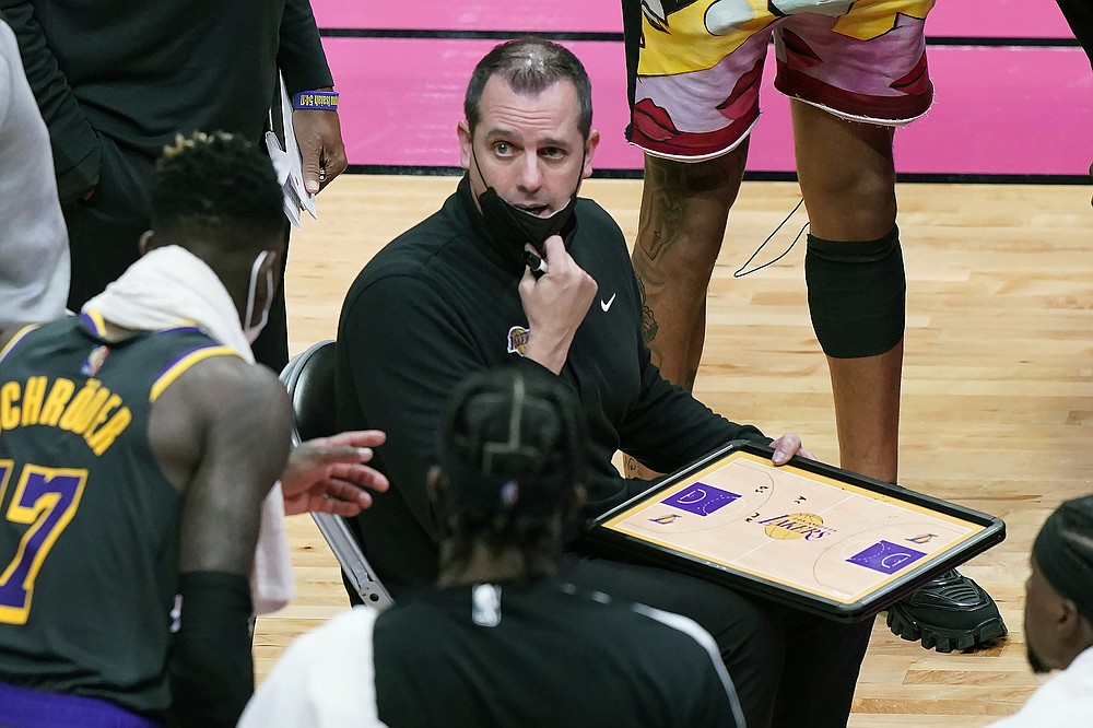 Los Angeles Lakers head coach Frank Vogel talks to guard Dennis Schroder (17) during a time out in the second half of an NBA basketball game against the Miami Heat, Thursday, April 8, 2021, in Miami. (AP Photo/Marta Lavandier)