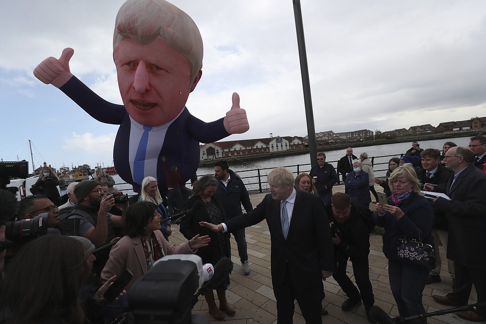 British Prime Minister Boris Johnson speaks to the media next to a large inflatable of him, after Conservative Party candidate Jill Mortimer won the Hartlepool by-election, at Hartlepool Marina, in Hartlepool, north east England, Friday, May 7, 2021. Britain's governing Conservative Party made further inroads in the north of England on Friday, winning a by-election in the post-industrial town of Hartlepool for a parliamentary seat that the main opposition Labour Party had held since its creation in 1974. (AP Photo/Scott Heppell)