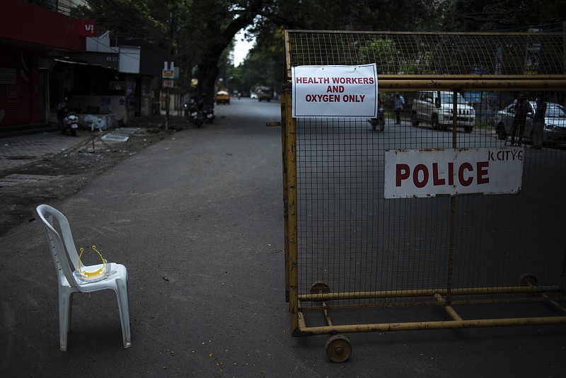 A signage is displayed on a barricade erected by police as part of imposing a lockdown to curb the spread of coronavirus in Kochi, Kerala state, India, Saturday, May 8, 2021. Kerala, which emerged as a blueprint for tackling the pandemic last year, began a lockdown on Saturday. (AP Photo/R S Iyer)