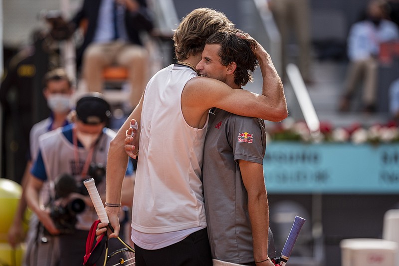 Germany's Alexander Zverev, left, embraces Austria's Dominic Thiem after winning the semi-final match at the Mutua Madrid Open tennis tournament in Madrid, Spain, Saturday, May 8, 2021. (AP Photo/Bernat Armangue)