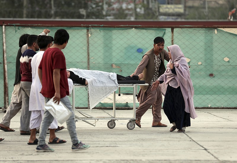 An injured school student is transported to a hospital after a bomb explosion near a school west of Kabul, Afghanistan, Saturday, May 8, 2021. A bomb exploded near a school in west Kabul on Saturday, killing several, many them young students, Afghan government spokesmen said. (AP Photo/Rahmat Gul)